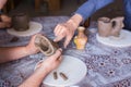 Man showing how to make clay mug in pottery studio - close up view