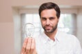 Man showing light bulb to camera Royalty Free Stock Photo