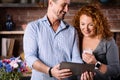 Man showing news on tablet to wife Royalty Free Stock Photo