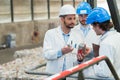 man showing objects to colleague with accusatory expression