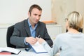 Man showing and offering blank white paper to customer Royalty Free Stock Photo