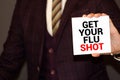Man showing paper with GET YOUR FLU SHOT text Royalty Free Stock Photo