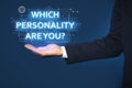 Man showing question Which personality are you? on virtual screen against dark blue background, closeup
