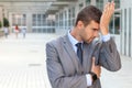 Man showing repentance with his family leaving him in the background Royalty Free Stock Photo