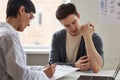 Man showing skin rash to doctor during consultation in dermatology clinic