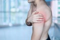 Man showing a sore shoulder