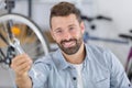 man showing spanner in bike store Royalty Free Stock Photo