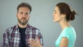 Man showing stop sign to annoyed wife who constantly screaming and complaining