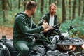 Man showing thumb up. Two male atv riders is in the forest together Royalty Free Stock Photo