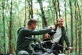Man showing thumb up. Two male atv riders is in the forest together Royalty Free Stock Photo