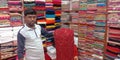 Man showing traditional sari to the store