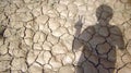 Man Showing Victory Finger with Cracked soil in Shadow