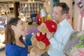 Man showing woman teddy bear