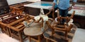 man showing wooden furniture at showroom for selling decorations item