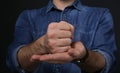 Man showing word CRUCIFY in sign language on black background Royalty Free Stock Photo