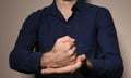 Man showing word CRUCIFY in sign language on color background