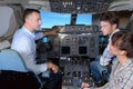 Man showing young people controls aircraft Royalty Free Stock Photo