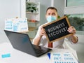 Man shows board with sign Business recovery and continuity plan. Royalty Free Stock Photo