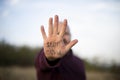 man shows hand with stop covid inscription