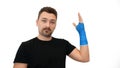 Man shows plaster cast on white background Royalty Free Stock Photo