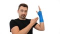 Man shows plaster cast on white background Royalty Free Stock Photo