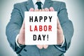 Man shows a signboard with the text happy labor day Royalty Free Stock Photo