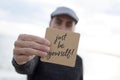 Man shows signboard with the text just be yourself