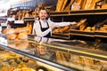 Man shows a variety of loaves of bread