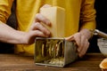 Man shredding cheese with metal grater Royalty Free Stock Photo