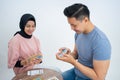Man shuffling cards while playing cards with a female friend Royalty Free Stock Photo