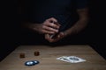 Man Shuffling Deck of Red Cards at Wooden Table Royalty Free Stock Photo