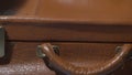 Man shutting vintage leather suitcase, packing for vacation, preparing for trip