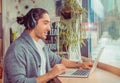 Man in side profile smiling having a online conversation, a video chat