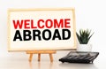 a man with a sign in his hands with an inscription welcome abroad