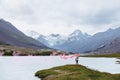 Man with signal fire on background of mountain lake