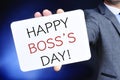 Man with a signboard with the text happy boss day