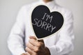 Man with a signboard with the text I am sorry Royalty Free Stock Photo