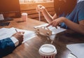 Man signing a car insurance policy, the agent is holding the wooden car model. Royalty Free Stock Photo