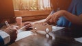 Man signing a car insurance policy, the agent is holding the wooden car model. Royalty Free Stock Photo