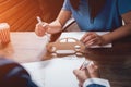 Man signing a car insurance policy, the agent is holding the wooden car model. Royalty Free Stock Photo