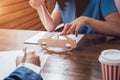 Man signing a car insurance policy, the agent is holding the wooden car model. Royalty Free Stock Photo