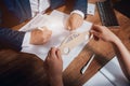 Man signing a car insurance policy, the agent is holding the wooden car model. Royalty Free Stock Photo