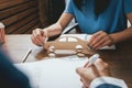 Man signing a car insurance policy, the agent is holding the wooden car model. Royalty Free Stock Photo