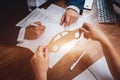 Man signing a car insurance policy, the agent is holding the wooden car model. Royalty Free Stock Photo