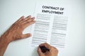 Man signing a contract of employment