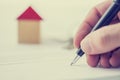 Man signing a deed of sale on a house Royalty Free Stock Photo