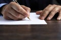 Man signing a document or writing correspondence Royalty Free Stock Photo