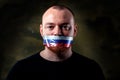 Man is silenced with adhesive russian flag tape across his mouth sealed Royalty Free Stock Photo
