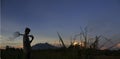 A silhouette of walking farmer going the workplace