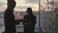 Man silhouette bringing coffee sunset office closeup. Couple drinking beverage